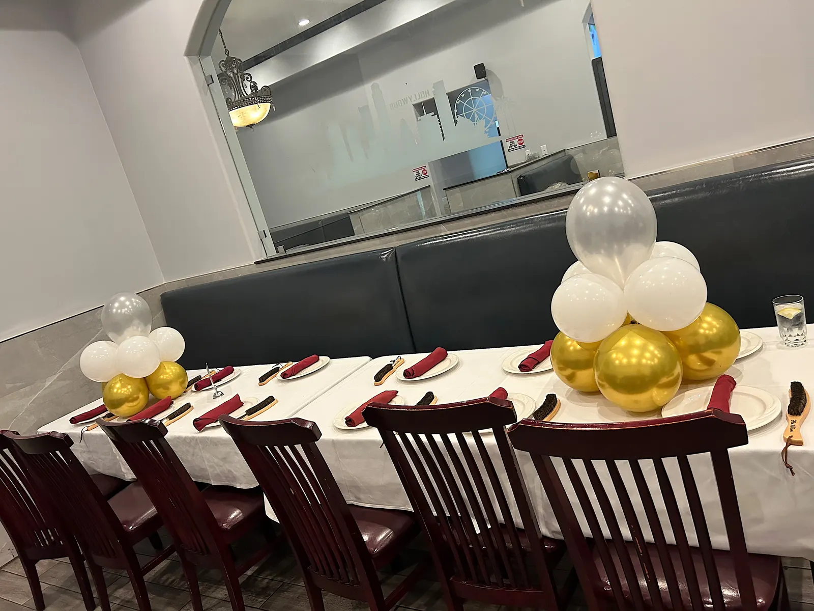 Gold and white balloon centerpieces along a long dinner table in Los Angeles