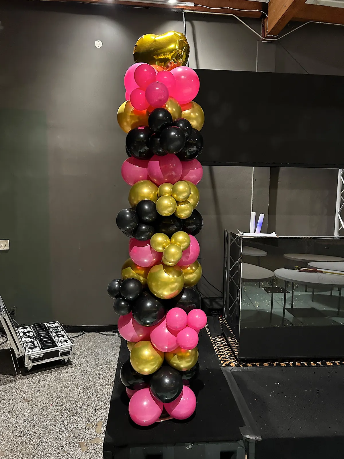 Hot pink, black and gold balloon column with a gold heart on top